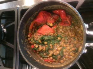 Lentils, red peppers, and spinach in pot, ready to be blended.